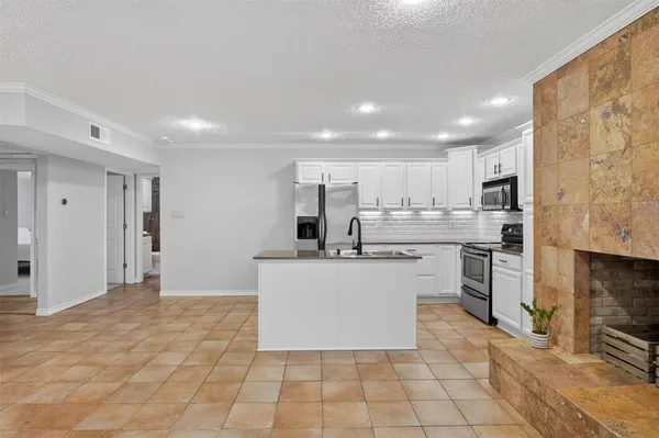 a kitchen with stainless steel appliances a refrigerator sink and cabinets