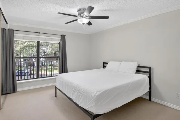 a large bed sitting in a bedroom next to a window
