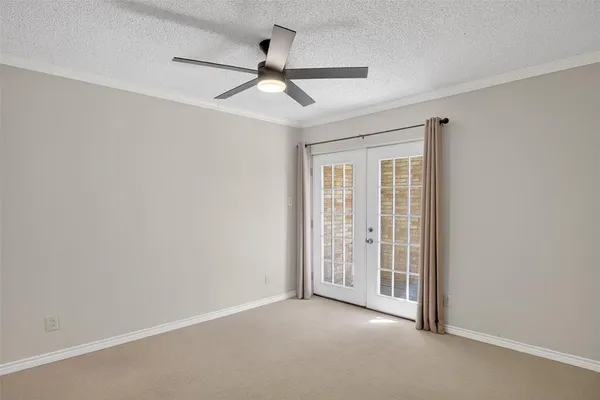 an empty room with a ceiling fan and a window