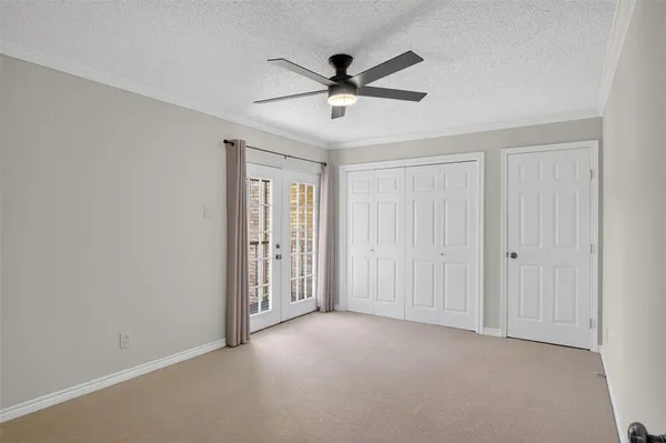 a view of an empty room with a ceiling fan