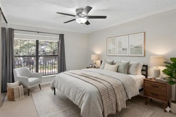 a bedroom with a bed and a large window