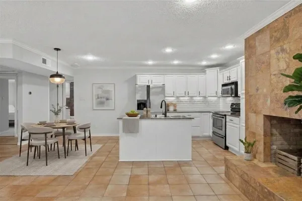 a kitchen with a table and chairs in it