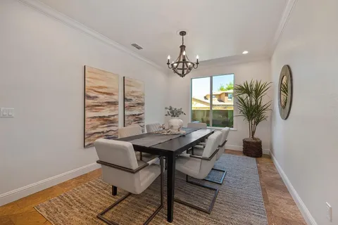 a living room with furniture a window and a potted plant