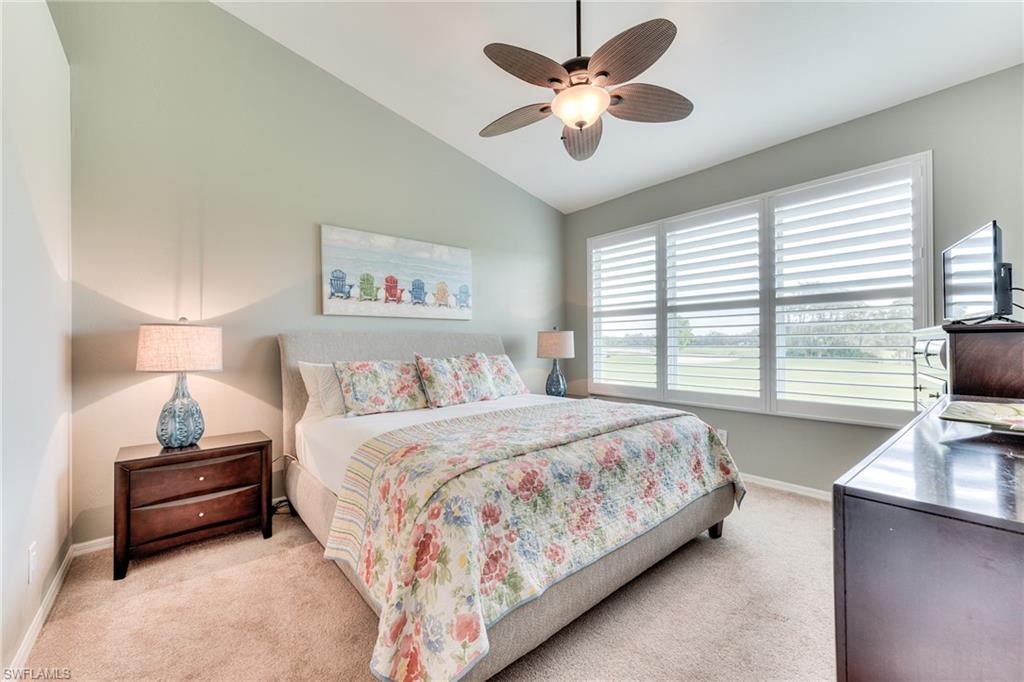 9281 Spring Run Boulevard, Unit 2602 Estero, FL 34135 - Photo 18 of 36 a bedroom with a large bed and a large window