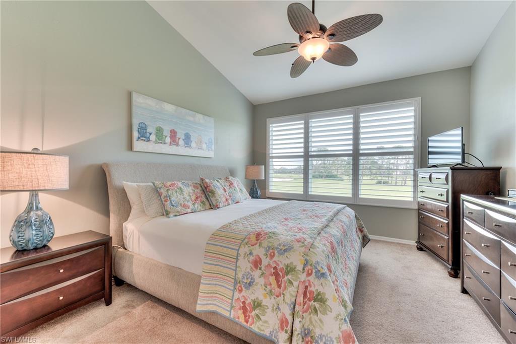 9281 Spring Run Boulevard, Unit 2602 Estero, FL 34135 - Photo 20 of 36 a bedroom with a large bed and a chandelier fan