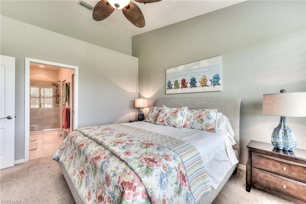 9281 Spring Run Boulevard, Unit 2602 Estero, FL 34135 - Photo 21 of 36 a bedroom with bed and wooden floor