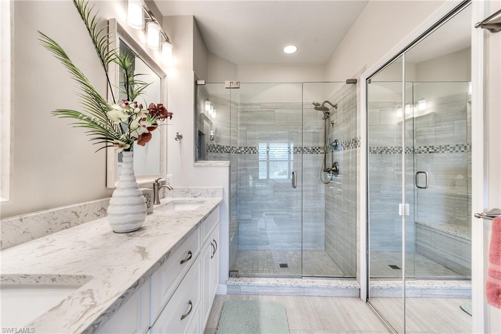9281 Spring Run Boulevard, Unit 2602 Estero, FL 34135 - Photo 24 of 36 a bathroom with double vanity and a shower