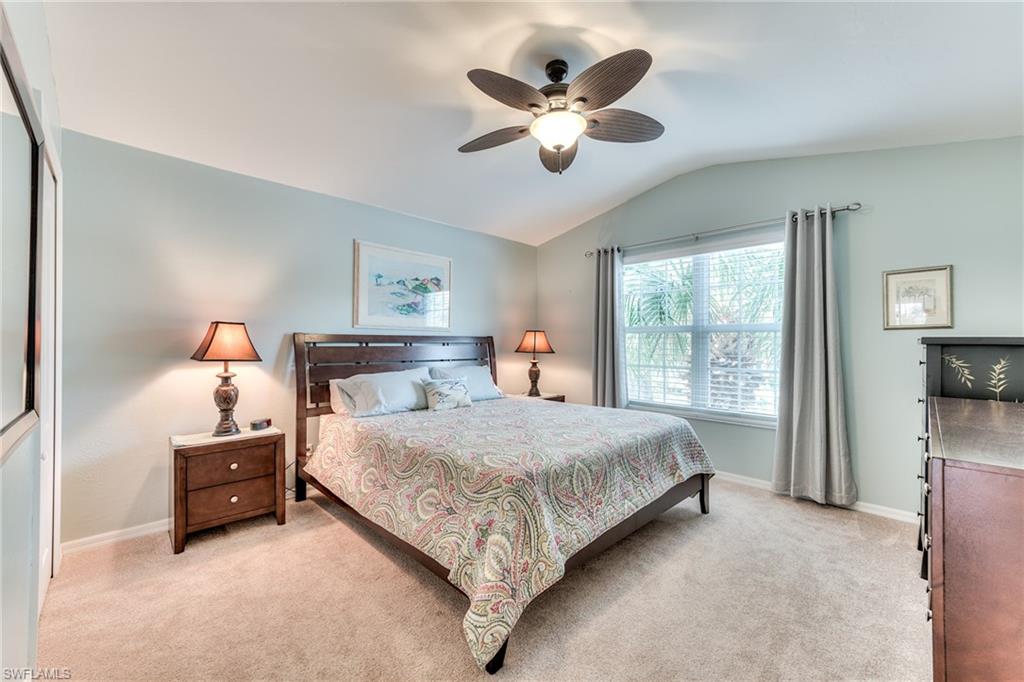 9281 Spring Run Boulevard, Unit 2602 Estero, FL 34135 - Photo 25 of 36 a bedroom with a large bed and a chandelier