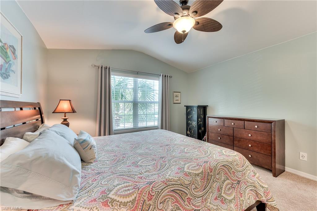 9281 Spring Run Boulevard, Unit 2602 Estero, FL 34135 - Photo 26 of 36 a bedroom with a large bed and a window