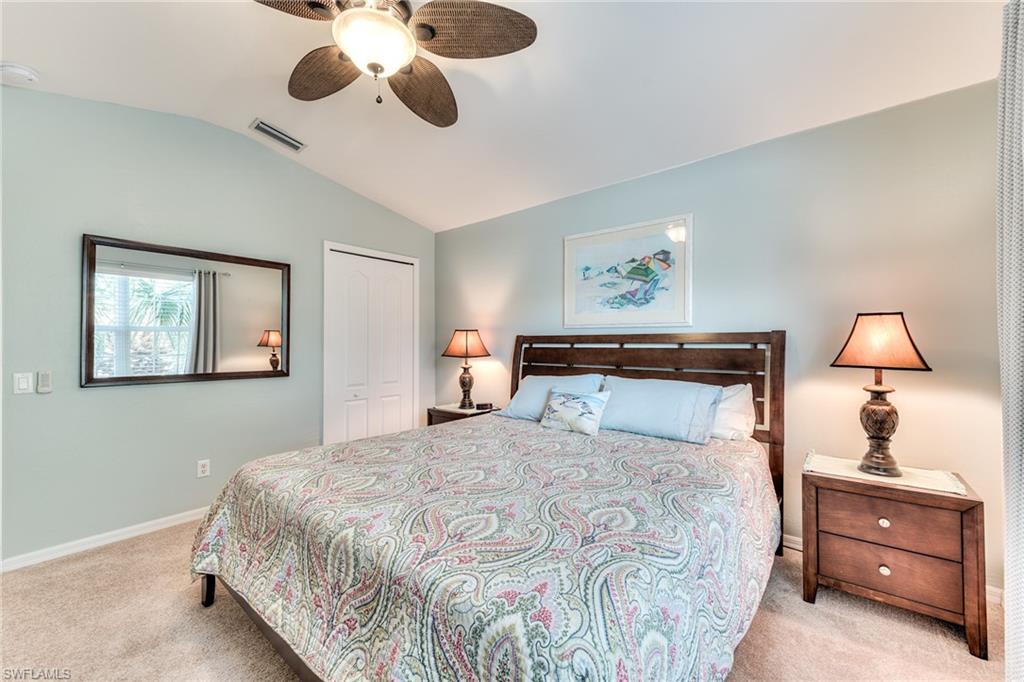 9281 Spring Run Boulevard, Unit 2602 Estero, FL 34135 - Photo 27 of 36 a bedroom with a large bed and a chandelier