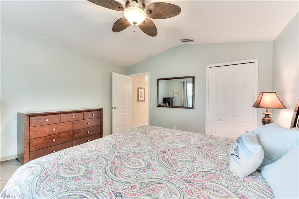 9281 Spring Run Boulevard, Unit 2602 Estero, FL 34135 - Photo 28 of 36 a bedroom with a bed and a chandelier