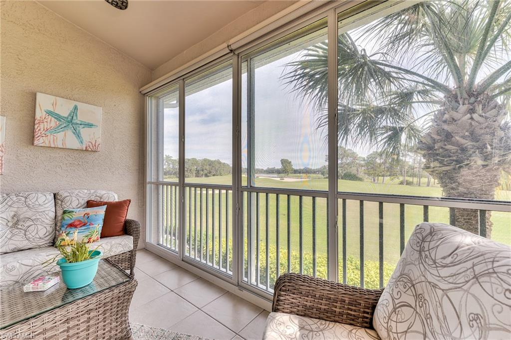 9281 Spring Run Boulevard, Unit 2602 Estero, FL 34135 - Photo 31 of 36 a balcony with furniture and a potted plant
