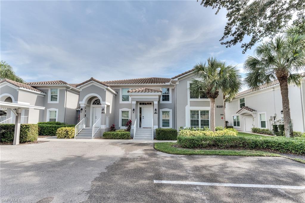 9281 Spring Run Boulevard, Unit 2602 Estero, FL 34135 - Photo 33 of 36 a front view of a house with a garden