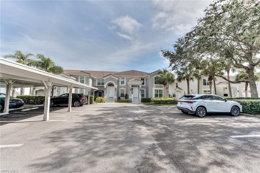 9281 Spring Run Boulevard, Unit 2602 Estero, FL 34135 - Photo 34 of 36 a view of street with parked cars