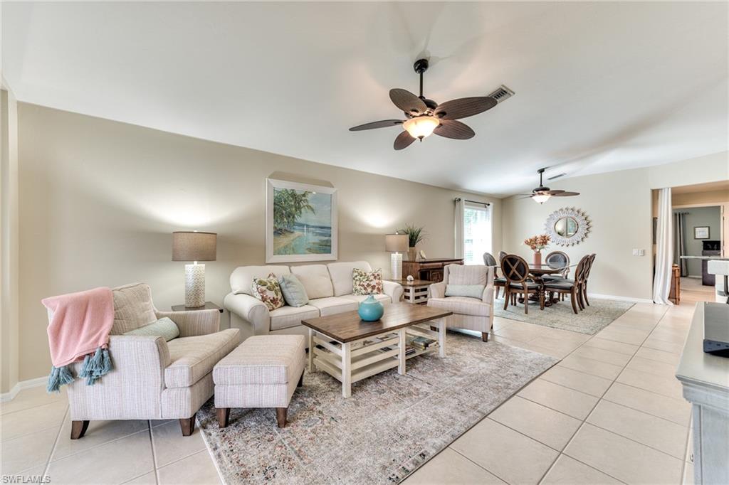 9281 Spring Run Boulevard, Unit 2602 Estero, FL 34135 - Photo 7 of 36 a living room with furniture and a chandelier