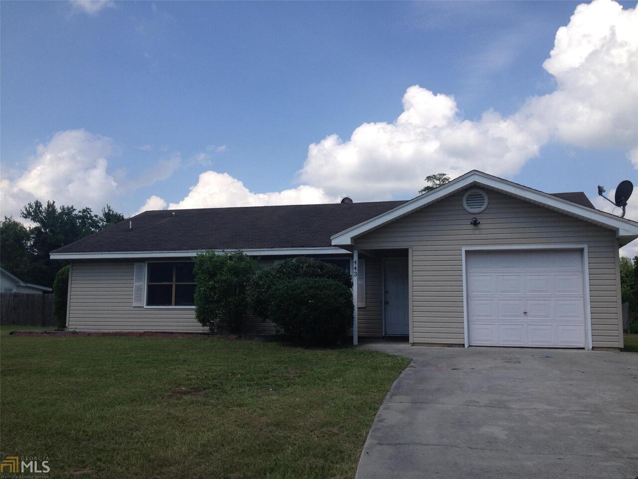 443 Powderhorn Road St. Marys, GA 31558 - Photo 1 of 1 a front view of house with yard and trees in the background