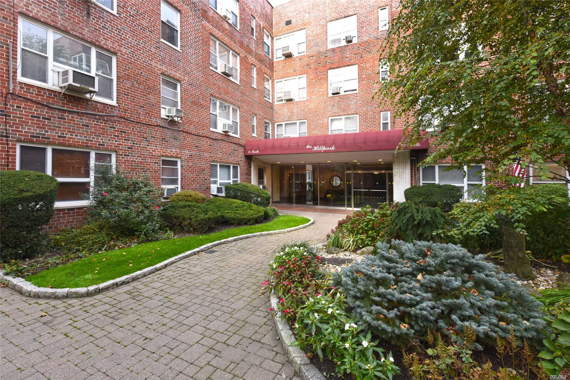 75 South Middle Neck Road, Unit 2O Great Neck, NY 11021 - Photo 1 of 1 a view of a building with a yard