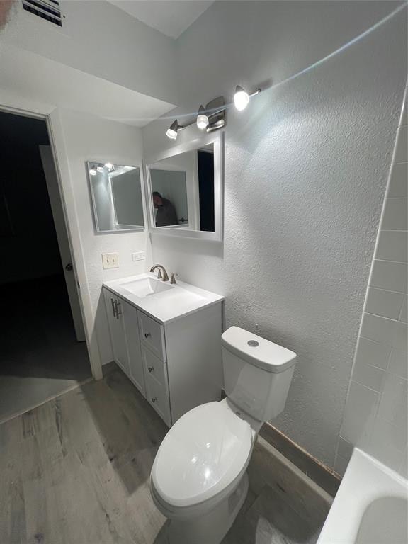 8100 Geneva Court, Unit 535 Doral, FL 33166 - Photo 11 of 27 a bathroom with a toilet sink and mirror
