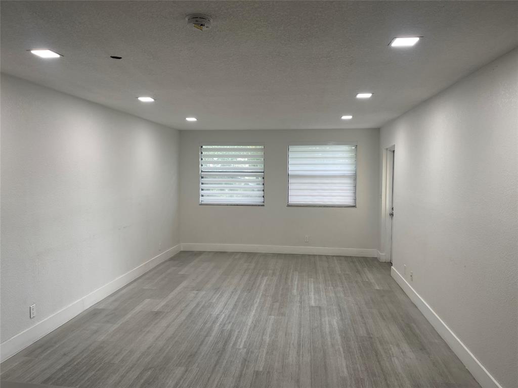 8100 Geneva Court, Unit 535 Doral, FL 33166 - Photo 14 of 27 an empty room with wooden floor and windows
