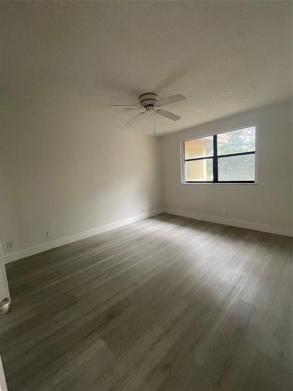 8100 Geneva Court, Unit 535 Doral, FL 33166 - Photo 16 of 27 an empty room with a window and a ceiling fan