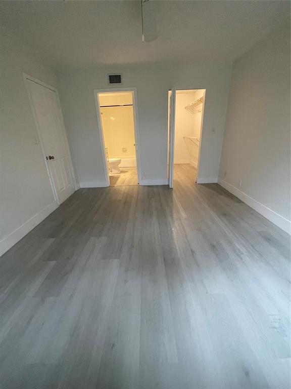 8100 Geneva Court, Unit 535 Doral, FL 33166 - Photo 18 of 27 an empty room with wooden floor and windows