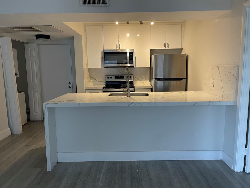 8100 Geneva Court, Unit 535 Doral, FL 33166 - Photo 21 of 27 a kitchen with a refrigerator and a stove top oven