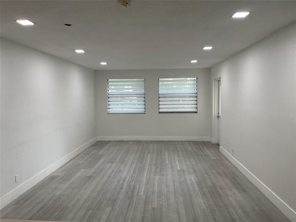 8100 Geneva Court, Unit 535 Doral, FL 33166 - Photo 22 of 27 an empty room with wooden floor and windows