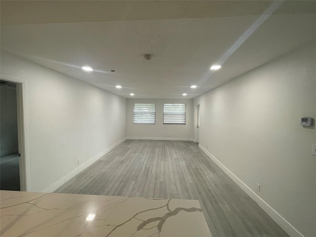8100 Geneva Court, Unit 535 Doral, FL 33166 - Photo 23 of 27 an empty room with wooden floor and windows