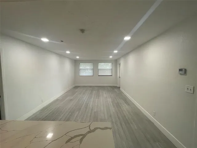 a kitchen with a sink and a mirror