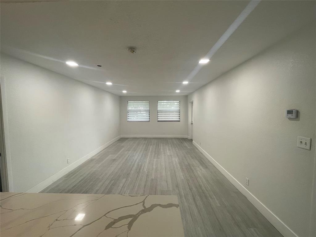 8100 Geneva Court, Unit 535 Doral, FL 33166 - Photo 24 of 27 an empty room with wooden floor and windows