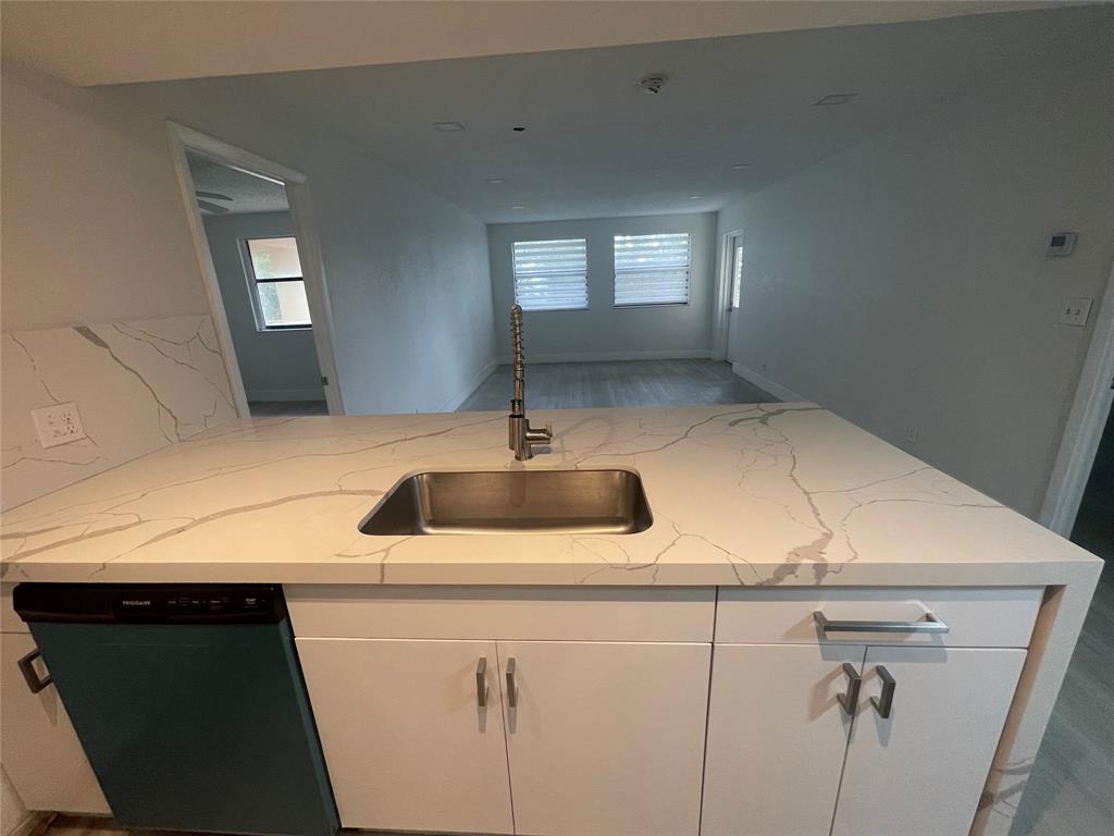 8100 Geneva Court, Unit 535 Doral, FL 33166 - Photo 25 of 27 a kitchen with a sink and a mirror
