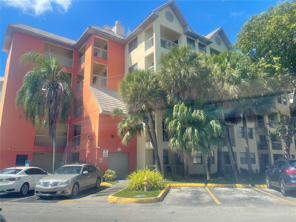 8100 Geneva Court, Unit 535 Doral, FL 33166 - Photo 26 of 27 a couple of cars parked in front of brick building