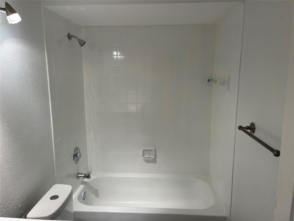 8100 Geneva Court, Unit 535 Doral, FL 33166 - Photo 8 of 27 a bathroom with a tub and a shower