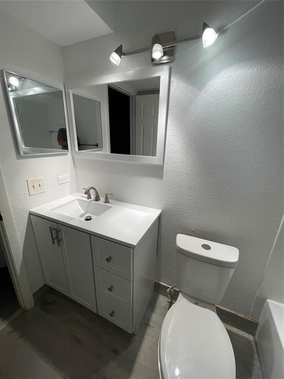 8100 Geneva Court, Unit 535 Doral, FL 33166 - Photo 10 of 27 a bathroom with a toilet sink and mirror