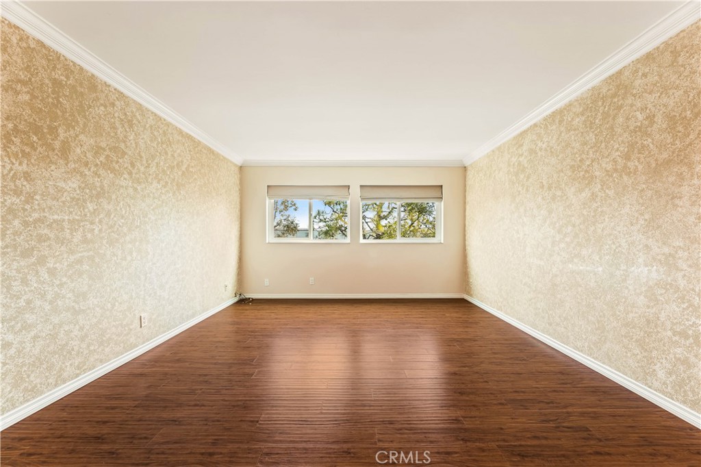 12300 Montecito Road, Unit 42 Seal Beach, CA 90740 - Photo 29 of 44 a view of an empty room with wooden floor and a window