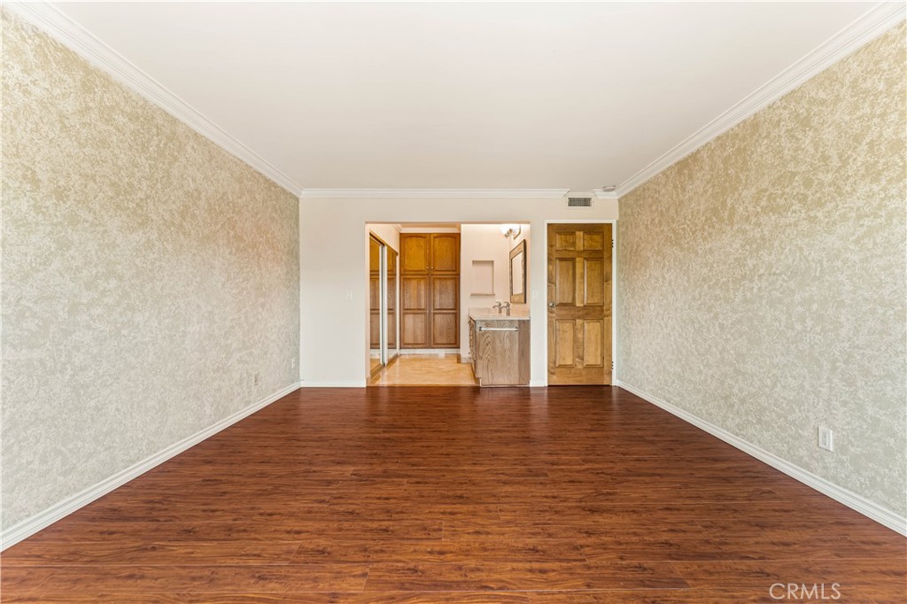 12300 Montecito Road, Unit 42 Seal Beach, CA 90740 - Photo 30 of 44 a view of an empty room with wooden floor and a window