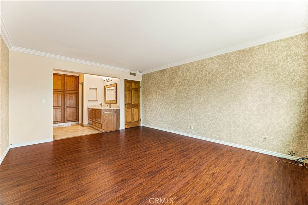 12300 Montecito Road, Unit 42 Seal Beach, CA 90740 - Photo 31 of 44 a view of an empty room with wooden floor and a window