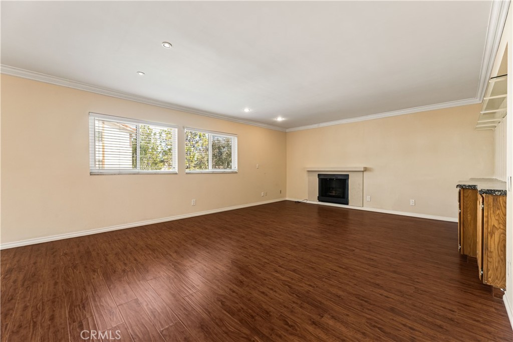 12300 Montecito Road, Unit 42 Seal Beach, CA 90740 - Photo 4 of 44 a view of an empty room with wooden floor and a window