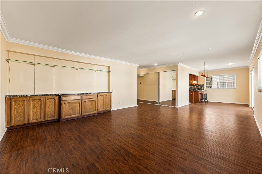 12300 Montecito Road, Unit 42 Seal Beach, CA 90740 - Photo 5 of 44 a view of an empty room with wooden floor and a window