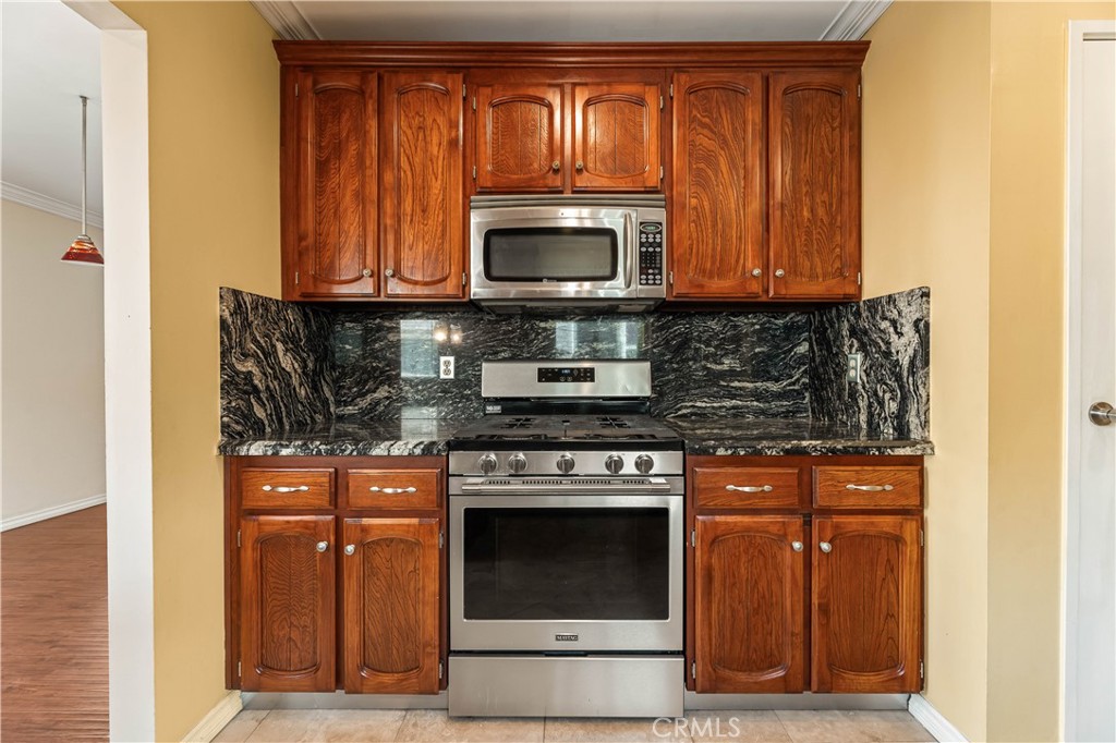 12300 Montecito Road, Unit 42 Seal Beach, CA 90740 - Photo 7 of 44 a stove top oven sitting inside of a kitchen