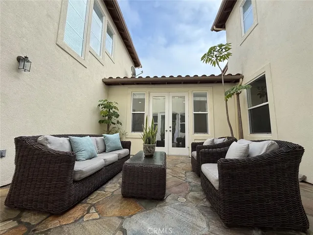 a balcony with furniture and wooden floor