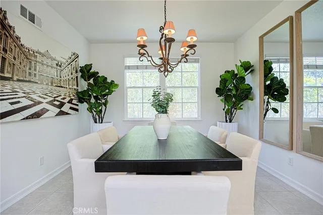 a dining room with furniture and potted plant