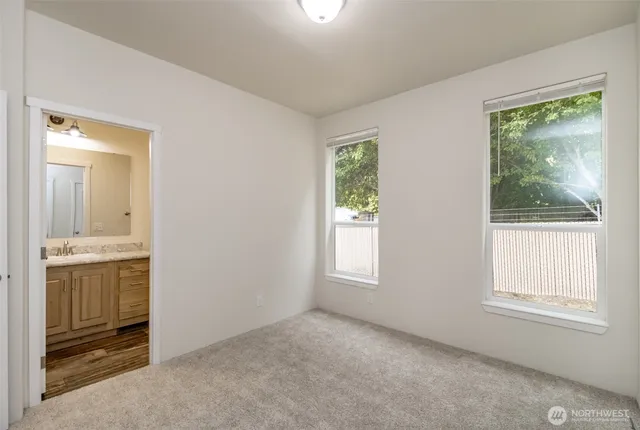an empty room with windows cabinet and mirror