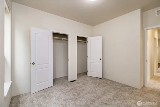 an empty room with closet area
