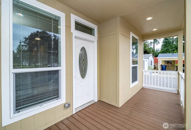 a view of a porch with wooden floor and a window