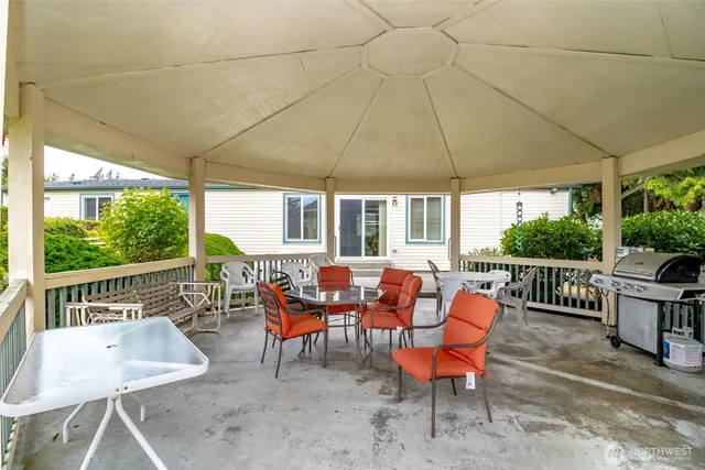 a patio with yard and outdoor seating