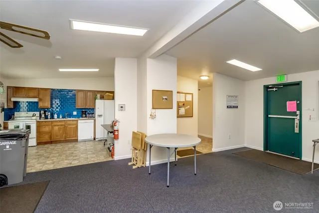 a living room with furniture and kitchen view