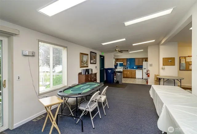 a view of a dining room with furniture and a large window