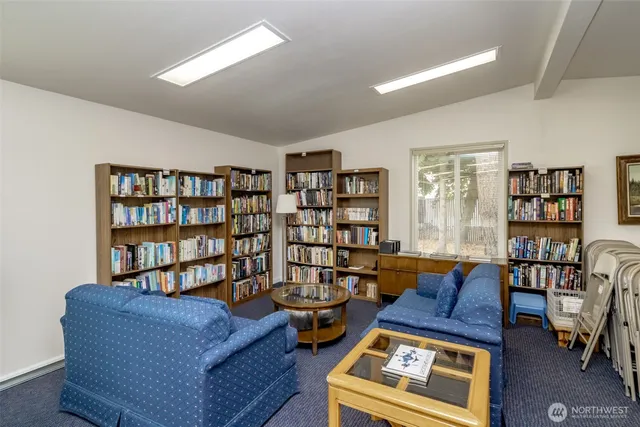 a living room with furniture and a book shelf