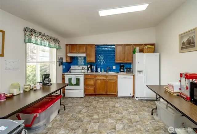 a kitchen with a refrigerator and a stove top oven